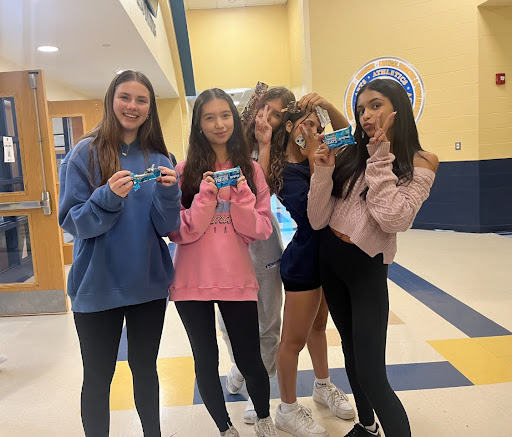 Students hold up Rice Krispie Treats which have increased in price to $1.25