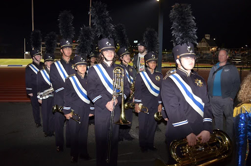 Marching band members line up for their performance