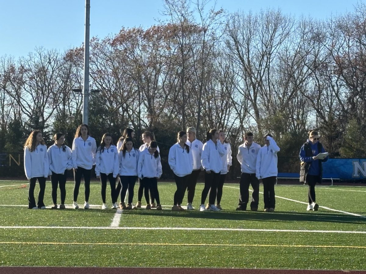 The varsity cheerleading team is honored at the pep-rally.