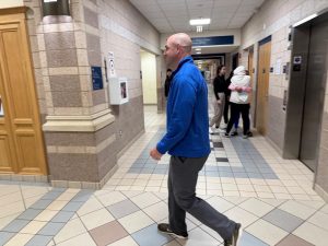 Principal Hugh Galligan strolls the halls.