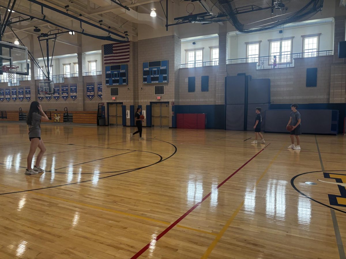 Freshmen playing basketball in wellness class