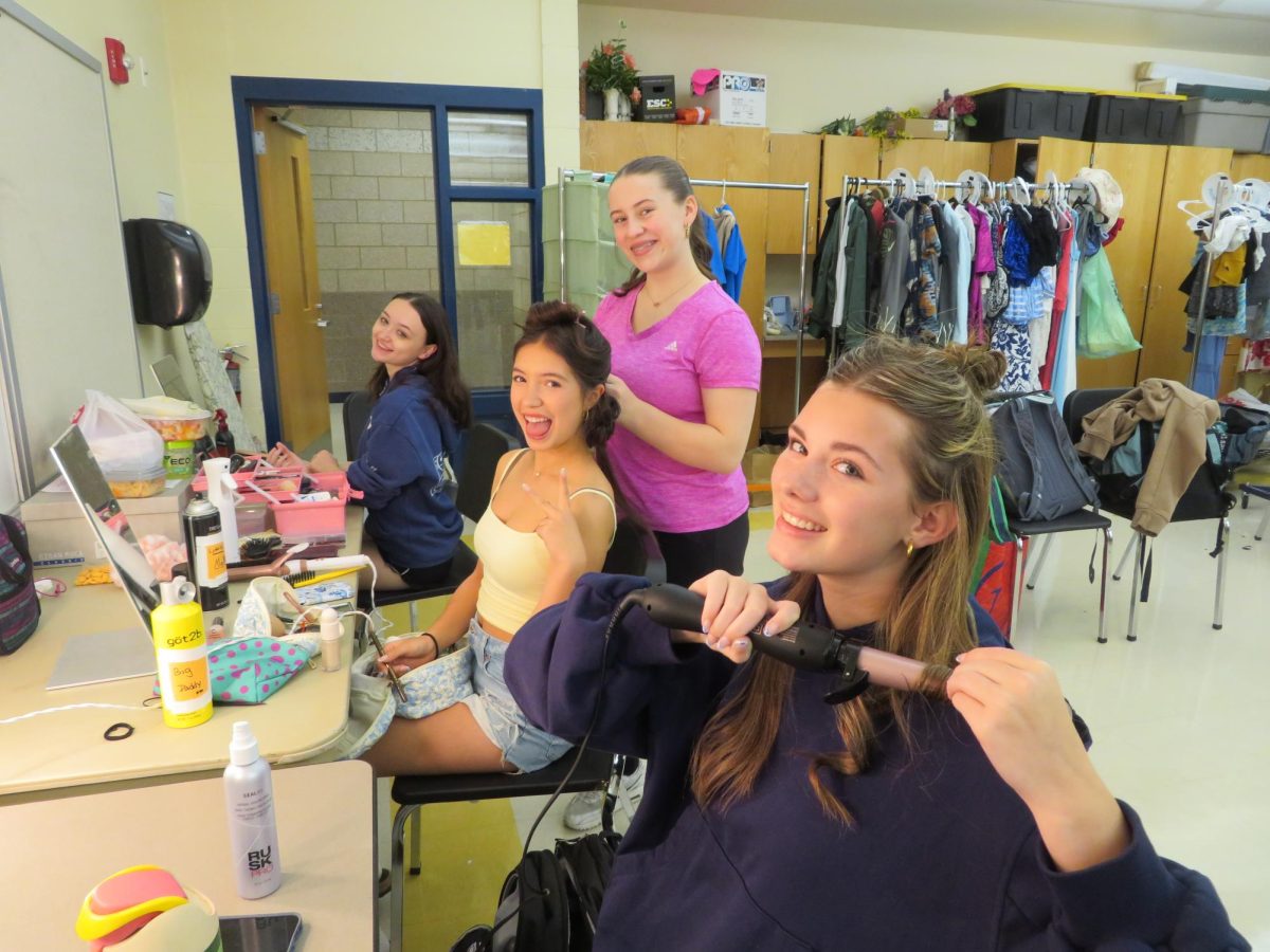 Senior Cayden Bell, Sophomore Angelina Giovangelo, Sophomore Danielle Frey, and Sophomore Margeaux Deeks getting ready on opening night (Left to Right)
