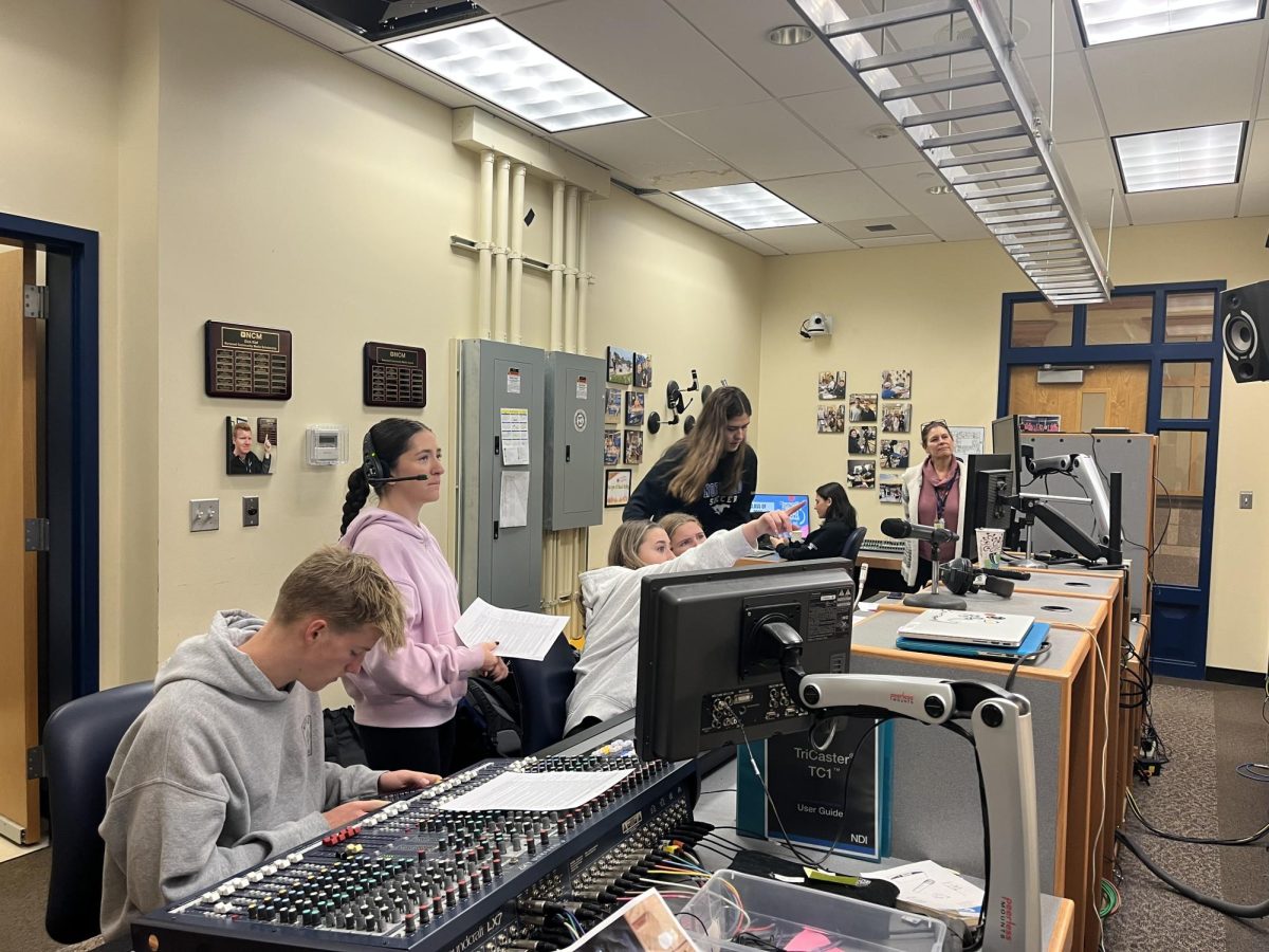 Norwood TV students working together behind the scenes of the morning new