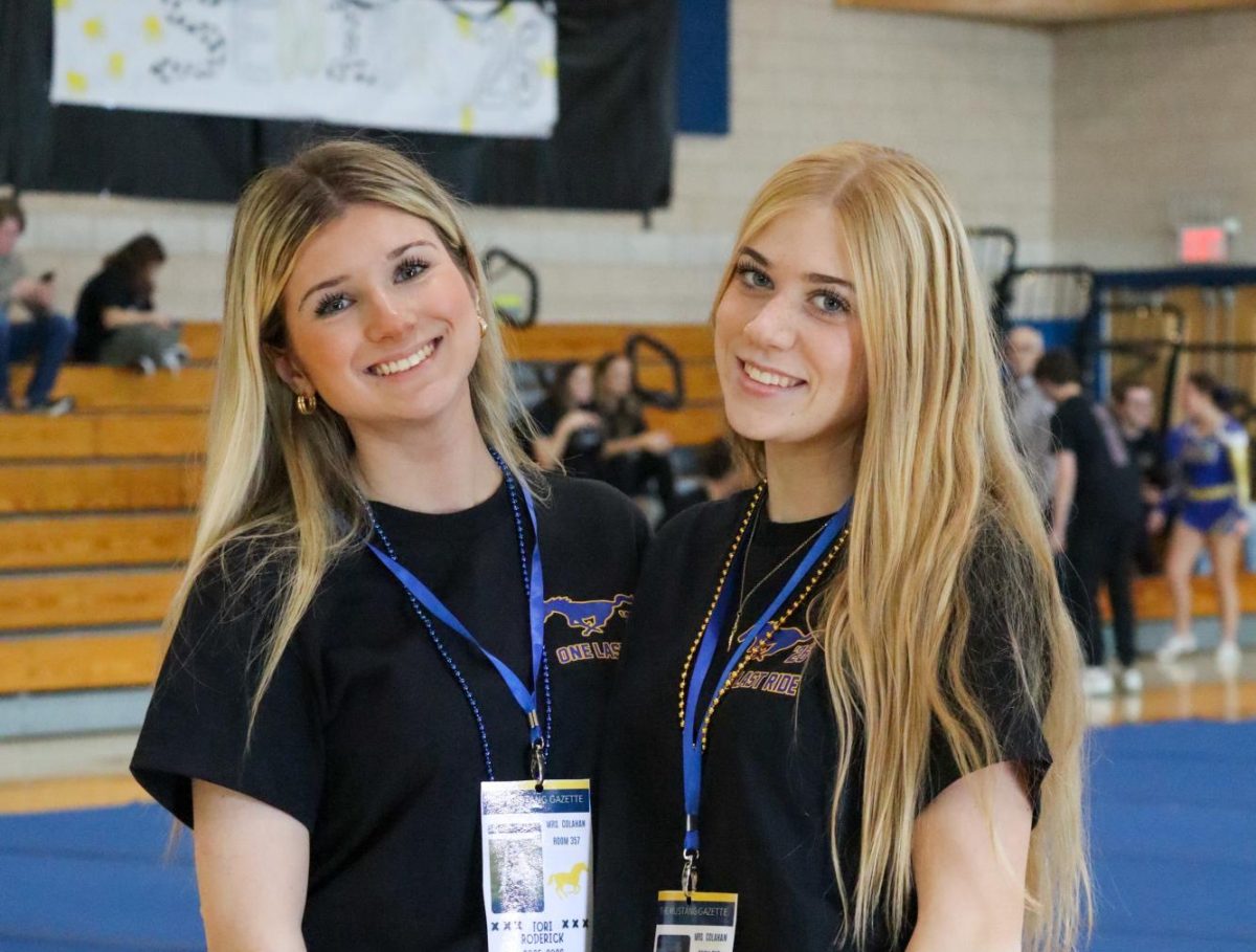 Senior co-editors Tori Roderick and Olivia Tucker (left to right) covering the pep rally.