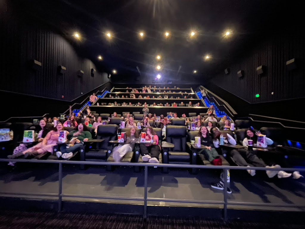 Students waiting for the movie before it starts.
