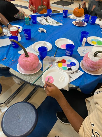 One of the activities at Friendship Club is to paint pumpkins!