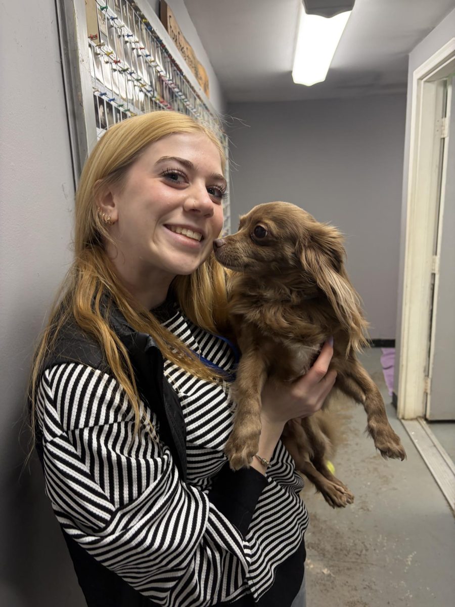 Co-Editor-in-Chief Olivia Tucker posing with furry friend Tony.