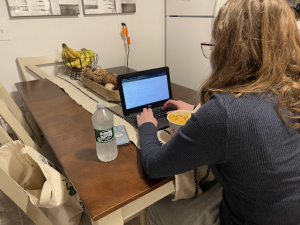 Meghan Savilia working on her latest creative writing project, a play called “A Prop That Tells a Story”, while eating her dinner.