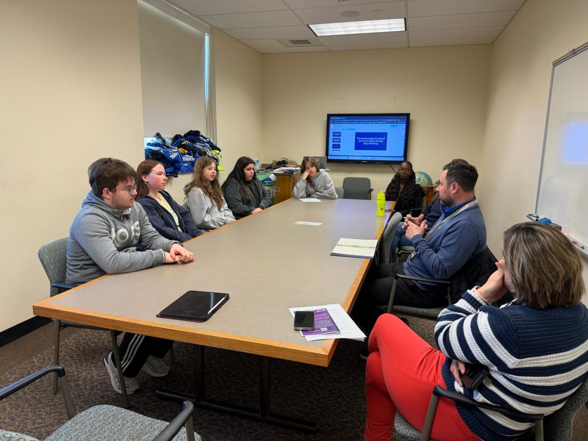 Students sit with Jason Morency to discuss concerns with school lunches