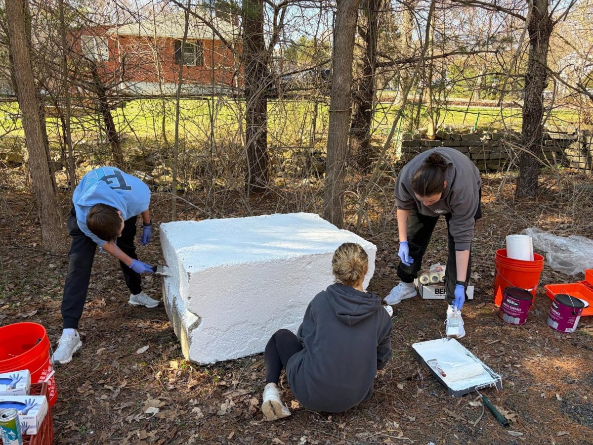 Volunteers help prep cement blocks for Earth Week Block Painting Event