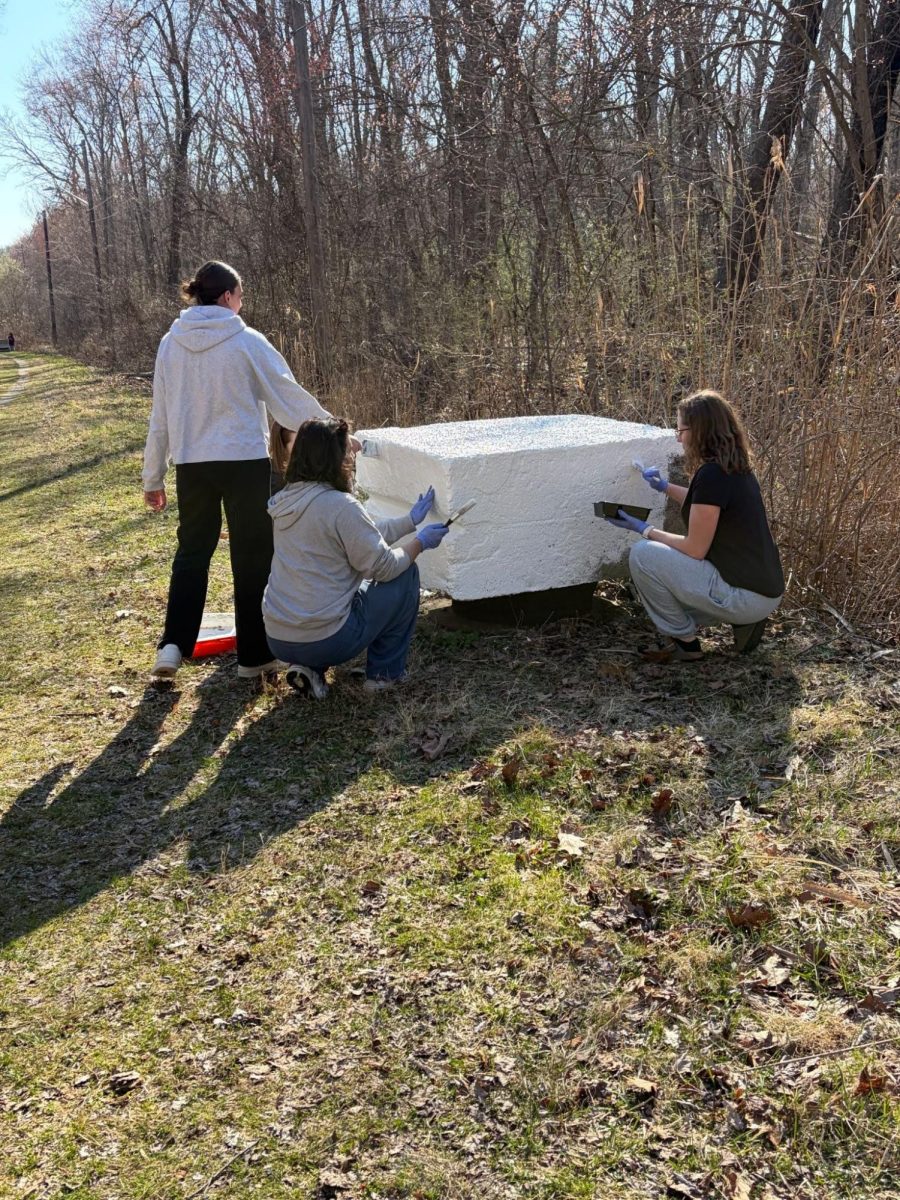 Volunteers help prep cement blocks for Earth Week Block Painting Event