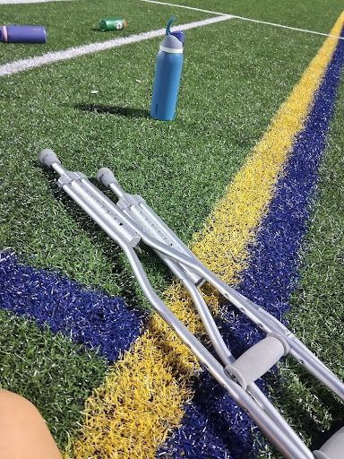 Sutherland with her crutches sitting
out at practice.
