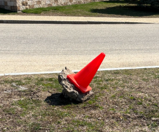 Up-rooted Traffic Cone in the NHS Parking Lot
